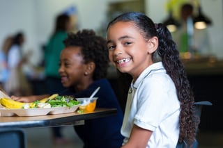 Cute-elementary-school-girl-eating-healthy-lunch-in-cafeteria-000043847850_Medium.jpg