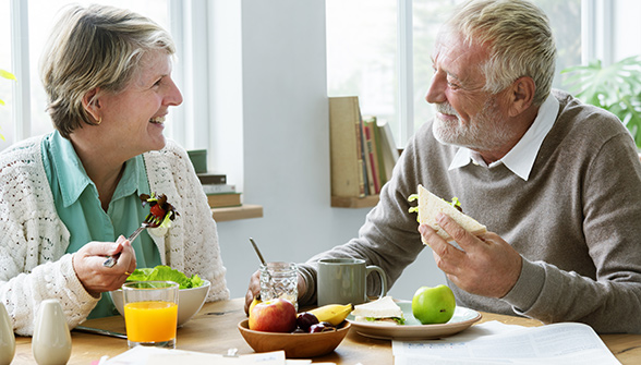 Senior Couple Eating at table