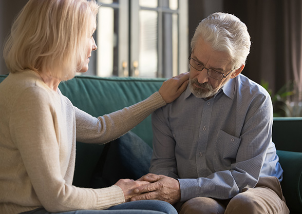 Woman consoling senior